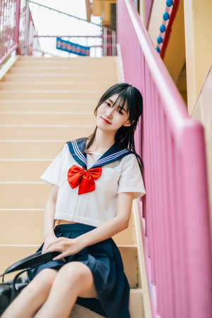 A girl in a JK sailor suit in the park