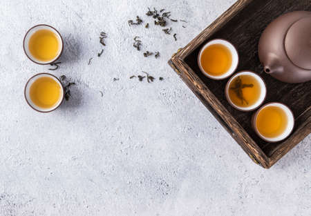 Tea leaves and tea set on a white backgroundの写真素材