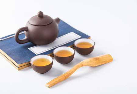 Tea leaves and tea set on a white background