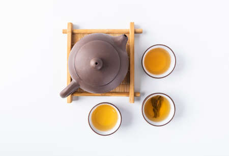 Tea leaves and tea set on a white backgroundの写真素材