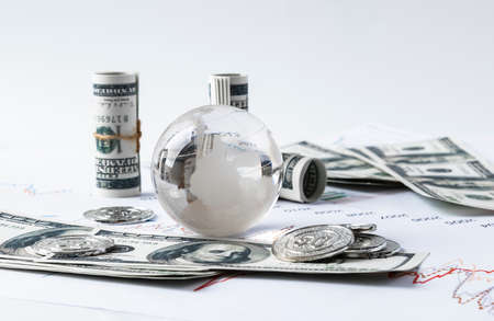 Glass globe and dollar billsの写真素材