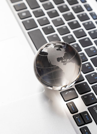glass globe on laptopの写真素材