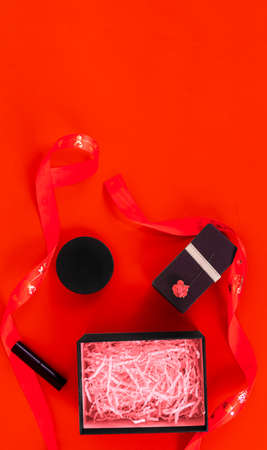 Gift box and ribbon on red backgroundの写真素材