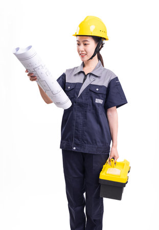 Female worker in overalls and hard hat with toolboxの写真素材
