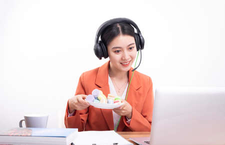 Asian female teacher with earphones teaching online class, online education
