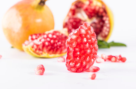 Ripe pomegranate fruit on a white background, isolatedの写真素材