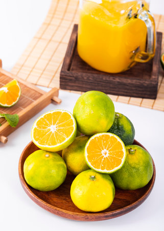 Orange juice and fresh oranges on white background - Healthy food and drinkの写真素材
