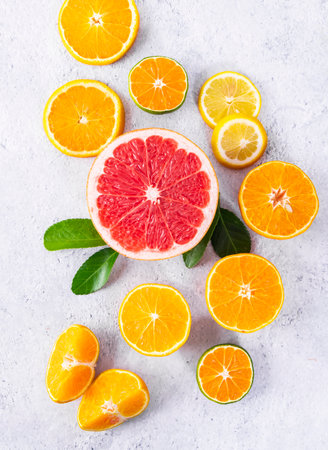 Slices of orange, lemon and grapefruit on light backgroundの写真素材