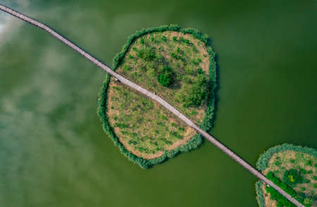 Aerial view of a country road in the middle of a lakeの写真素材