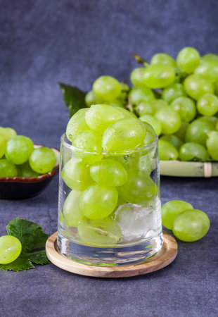 Fresh green grapes in a glass with ice cubes, selective focus.の写真素材