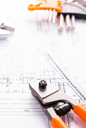 Tools and rolls of drawings for the construction of a house or officeの写真素材