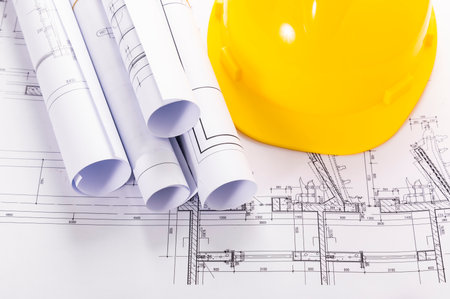 Architectural plans and yellow helmet on the background of drawings.の写真素材