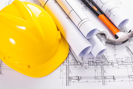 Architectural plans and yellow helmet on the construction drawing of a houseの写真素材