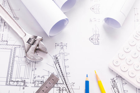 Tools and rolls of drawings for the project engineer jobs on the tableの写真素材