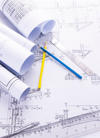 Architectural blueprints and rolls of blueprints with drawing toolsの写真素材