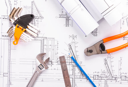 Drawing of a house and tools on the background of blueprintsの写真素材