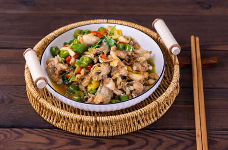 Stir-fried chicken with vegetables in a bowl on wooden backgroundの写真素材