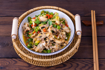 Stir fried chicken with mushrooms and vegetables in a bowl on wooden backgroundの写真素材
