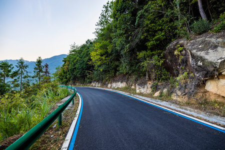 Winding road in the forest, Thailand. Mountain road with blue sky.の写真素材