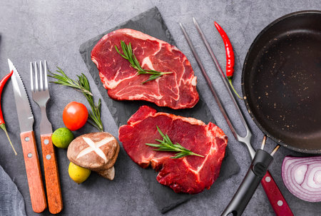 Raw beef steak with ingredients for cooking. Top view with copy spaceの写真素材