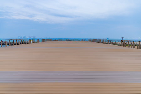 Wooden walkway on the beach with blue sky and sea backgroundの写真素材