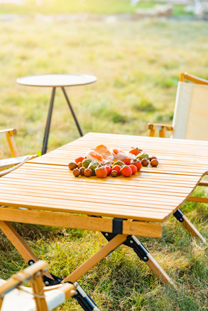 Autumn picnic with chestnuts on wooden table in the garden.の写真素材