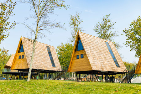 Wooden houses in the park on a background of blue sky.の写真素材