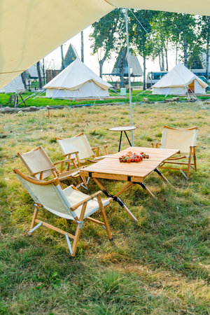 Wedding chairs and table in a tent on a meadowの写真素材