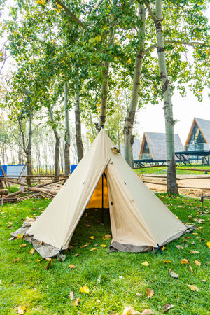 Camping tent on green grass at campground in autumn, Thailand.の写真素材