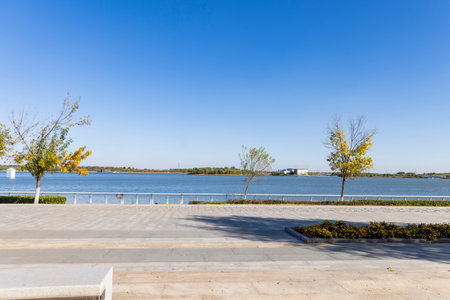 Autumn landscape in the park, the lake and the blue skyの写真素材