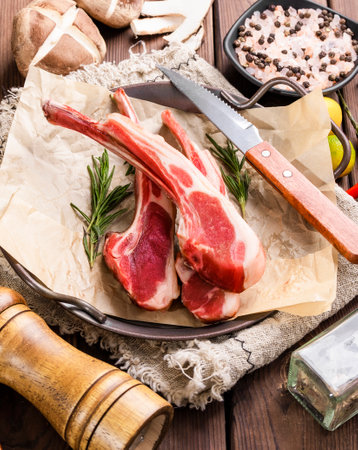 Raw lamb chops with ingredients for cooking on wooden background. Selective focus.の写真素材