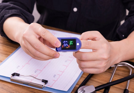 Closeup of a woman measuring blood pressure with a pulse oximeterの写真素材