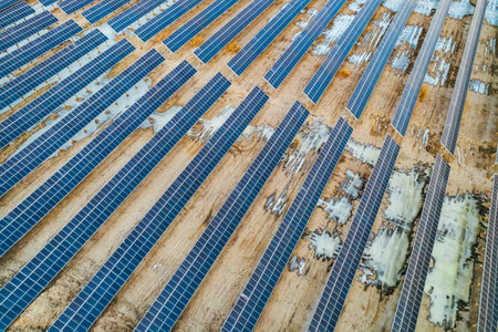 Aerial view of solar power plant with many rows of photovoltaic panels.の写真素材