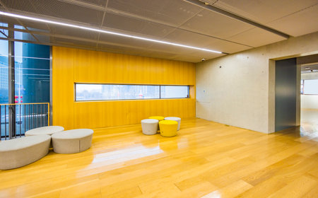 Interior of a modern office building with bright yellow walls and floorの写真素材