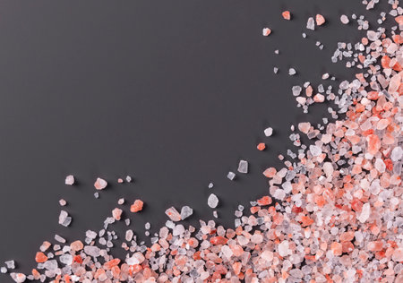 Pink salt on a black background. Top view. Flat lay.の写真素材