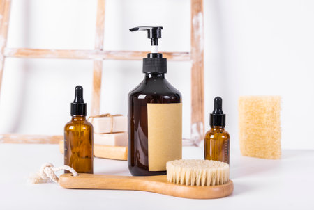cosmetic bottles with a dispenser and a brush on a white backgroundの写真素材
