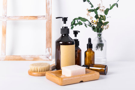 Spa composition with soap, massage brush and shampoo bottles on white backgroundの写真素材