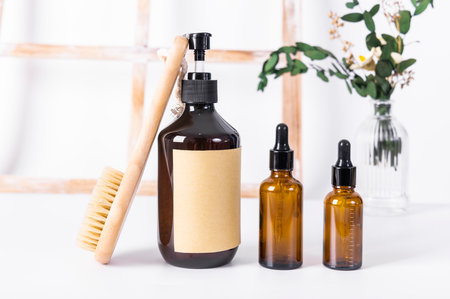 massage oil in a glass bottle with a brush on a white backgroundの写真素材