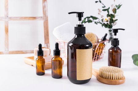 Cosmetics bottles with blank label and massage brush on white background.の写真素材