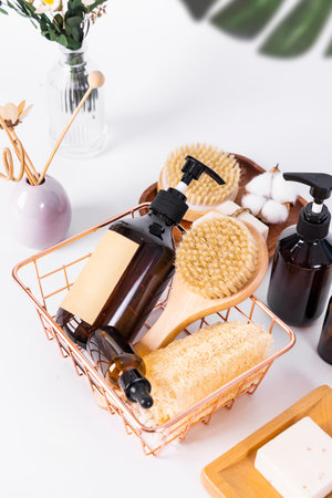 Spa and body care products in a basket on a white backgroundの写真素材