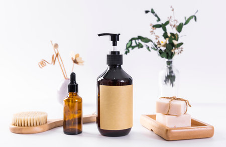Spa still life with brown bottle, soap and wooden brush on white backgroundの写真素材