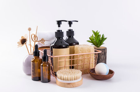 Spa still life on white background. Natural cosmetics, massage brushes, bath salt and oil.の写真素材