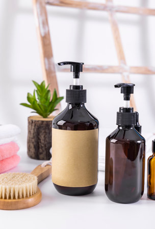 Cosmetic bottles with blank label on the background of bathroom accessories.の写真素材