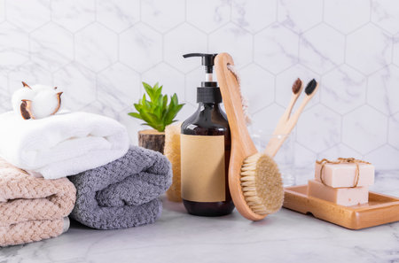 Spa and wellness setting. Towels, soap, loofah, shampoo, bath salt, massage brush.の写真素材