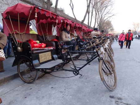 Row of rickshaw parked along streets of old beijingの素材