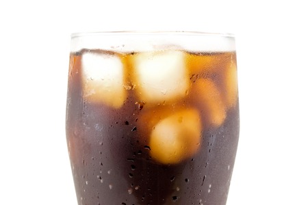 Cola with ice cube in glass closeup isolated on white backgroundの写真素材