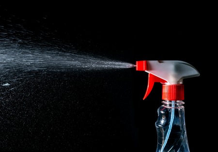 cleaner spray, stream of cleaner spray isolated on a black background