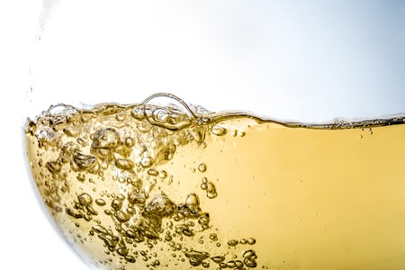 Wine in glass closeup, macro, wave of wine, splashing, splash, bubbles, texture, fizzの写真素材