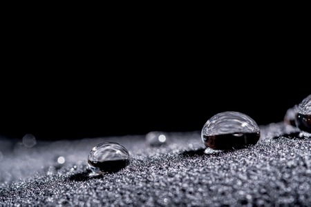 Drops of water close-up macro on velvet materialの写真素材