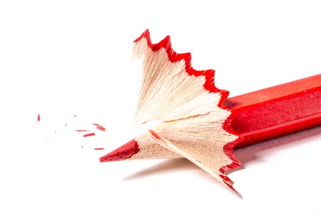 Red pencil with shavings on a white background texture close-up macroの写真素材